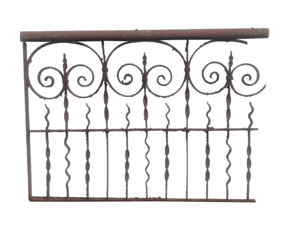 Wrought iron fence section with scrollwork and fleur de lis finials, shown in a straight-on view.