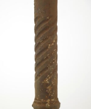 Close-up of a cast iron corner post with a twisted spiral design and visible wear.