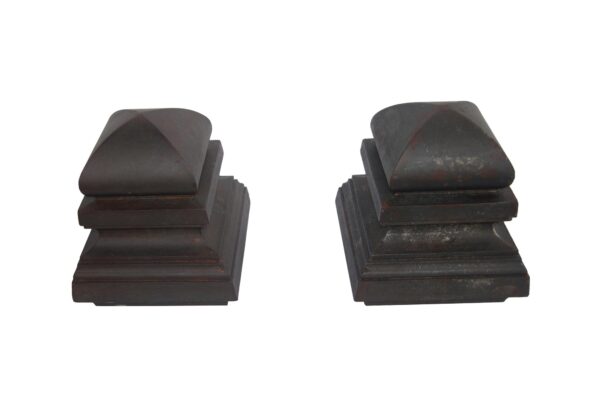 Pair of cast iron finials with a black finish, shown as a matching pair from two angles.