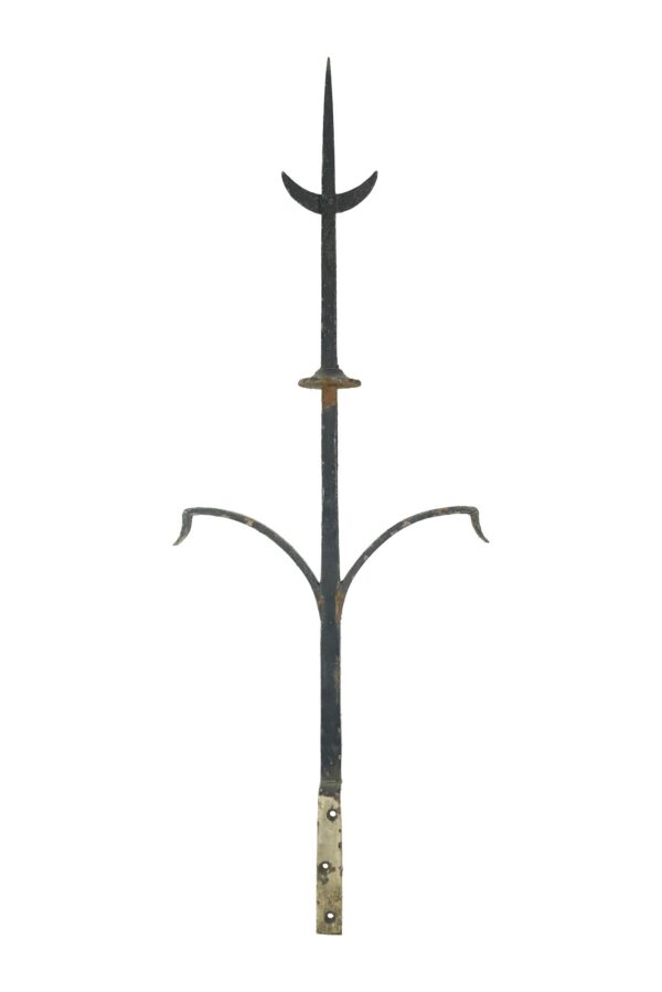 Gothic wrought iron roof finial with a tall pointed center spike, curved side arms, and visible wear and rust on the lower mounting section.
