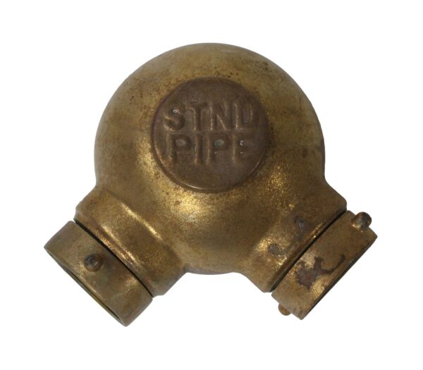 Bronze fire hose standpipe with a rounded top and two angled side fittings, shown in close-up with a circular STAND PIPE marking on the front.