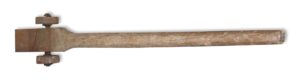 Antique wooden-handled dolly with an iron plate and two visible wheels shown in side view.