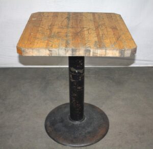 Bistro cafe table with a light wood tone butcher block top and cast iron base, shown in a front view with a square top.