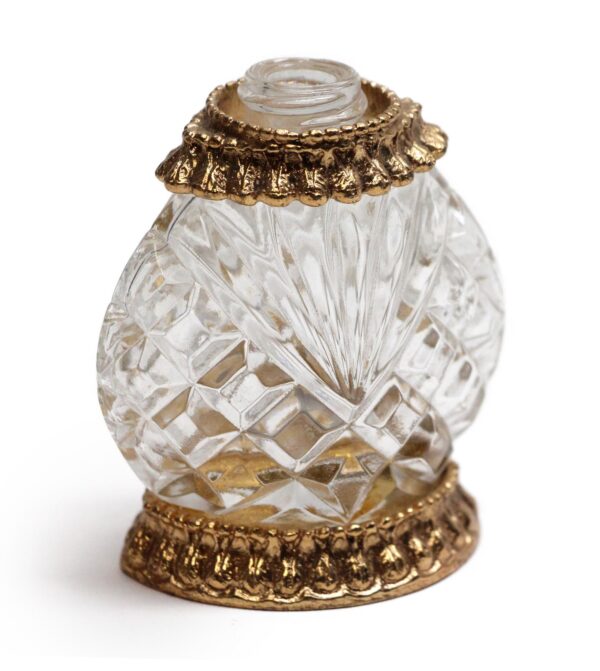 Clear glass perfume bottle with decorative polished brass trim and no top.
