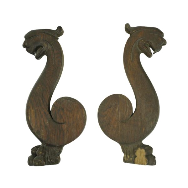 Pair of pine wood snake carvings shown as two matching decorative figures with curled bodies and open mouths, photographed side by side and viewed full length.
