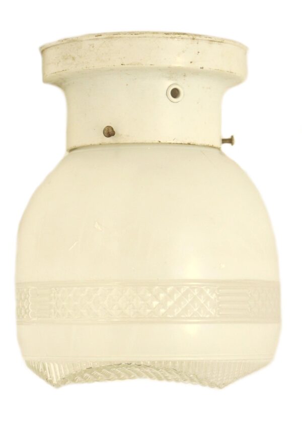 White and clear glass semi flush mount light with a white fitter, shown in a close-up view of the fixture’s upper and lower sections.