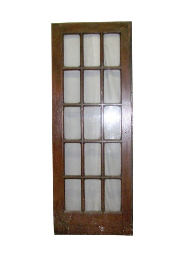 A dark wood tone door with 15 glass panels arranged in a grid.