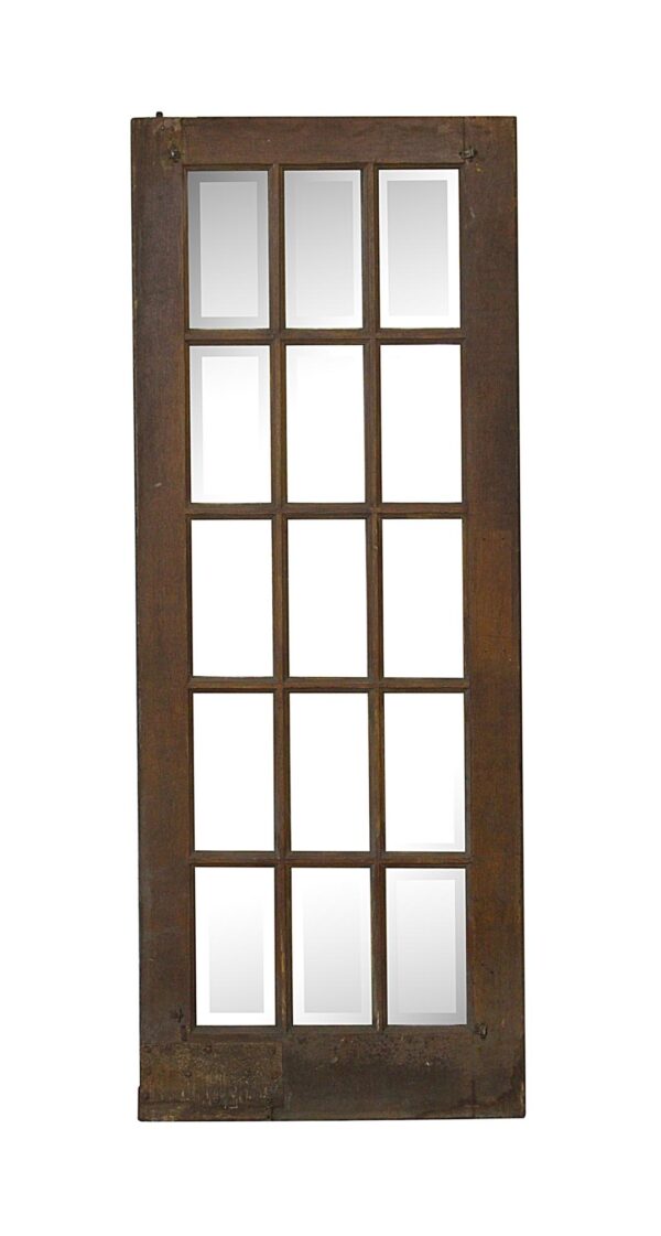 Dark wood tone French door with 15 beveled glass panes arranged in a vertical grid.
