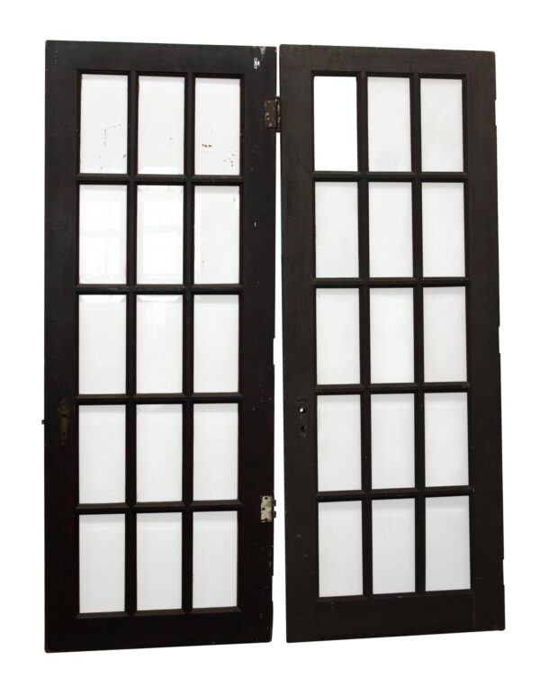 Pair of dark wood tone French doors with 15 beveled glass panes each, shown closed and upright side by side.