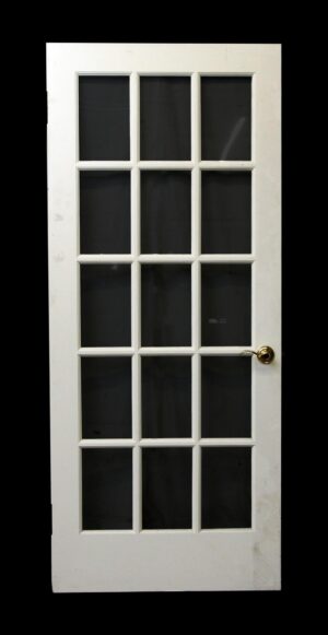 White wood French door with 15 glass panes and a round brass knob.
