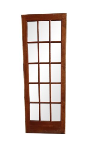 Dark wood tone French door with 15 glass lites and visible wood wear, shown straight on.