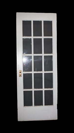 White wood French door with 15 vertical glass lites and a visible handle plate on the left side, shown in a full-length front view with two broken glass panels.