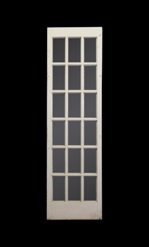 Vintage white French passage door with 18 glass panes in a tall narrow frame.