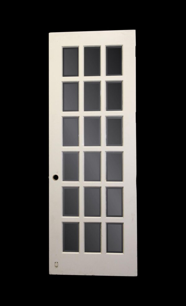 White wooden French door with 18 rectangular mirrored lites and a round bore hole visible near the lower left side.