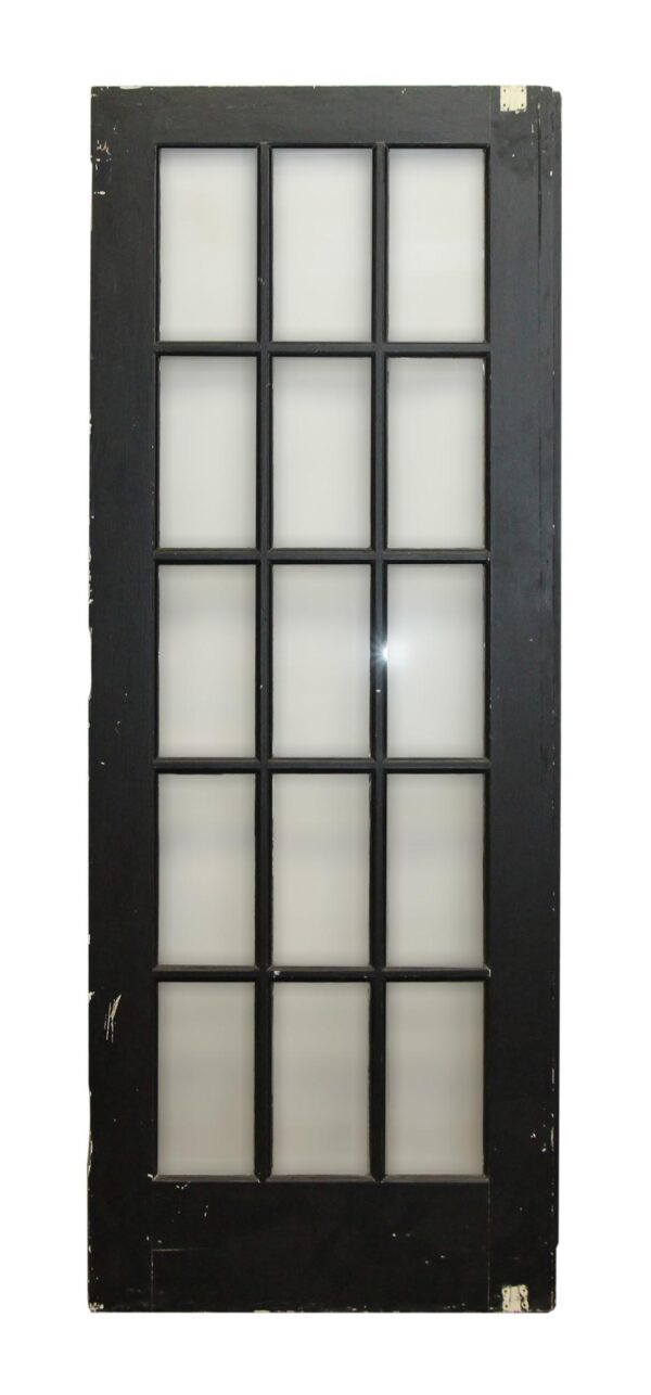 Black wood French door with 15 glass panes, shown vertically without hardware attached.