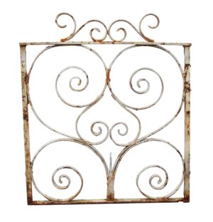 Antique small wrought iron gate with white paint and rusted scrollwork.