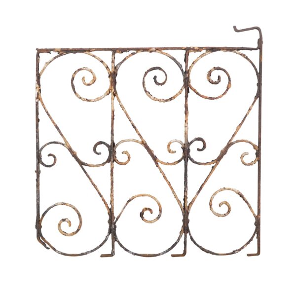 Wrought iron gate panel with curled scrollwork in a solid frame, shown front view with visible rust and age wear.