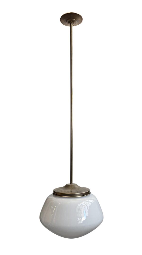 Schoolhouse pendant light with a long brass rod and a white milk glass globe shade.