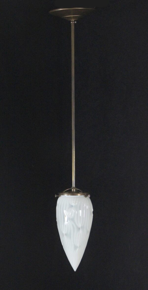 Pendant light with a long brass stem and a white opalescent glass cone shade.