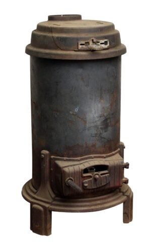 Cast iron wood burner with a tall cylindrical body, domed top, front loading door, and three-legged base, shown with a black finish and visible wear.