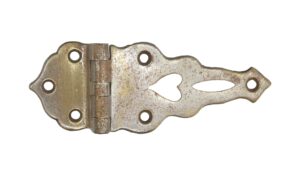 Antique nickel-plated bronze ice box hinge with five screw holes and a decorative cutout on the longer leaf.