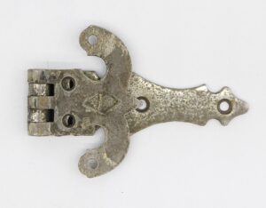 Antique ice box hinge with a curved plate, three mounting holes, and visible surface wear from prior use.