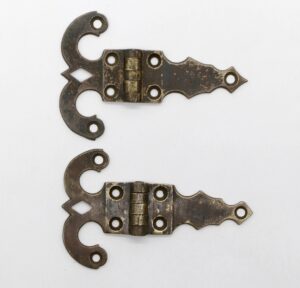 Pair of antique bronze ice box hinges shown stacked vertically, each with five knuckles and multiple mounting holes, in a worn surface-mount style.