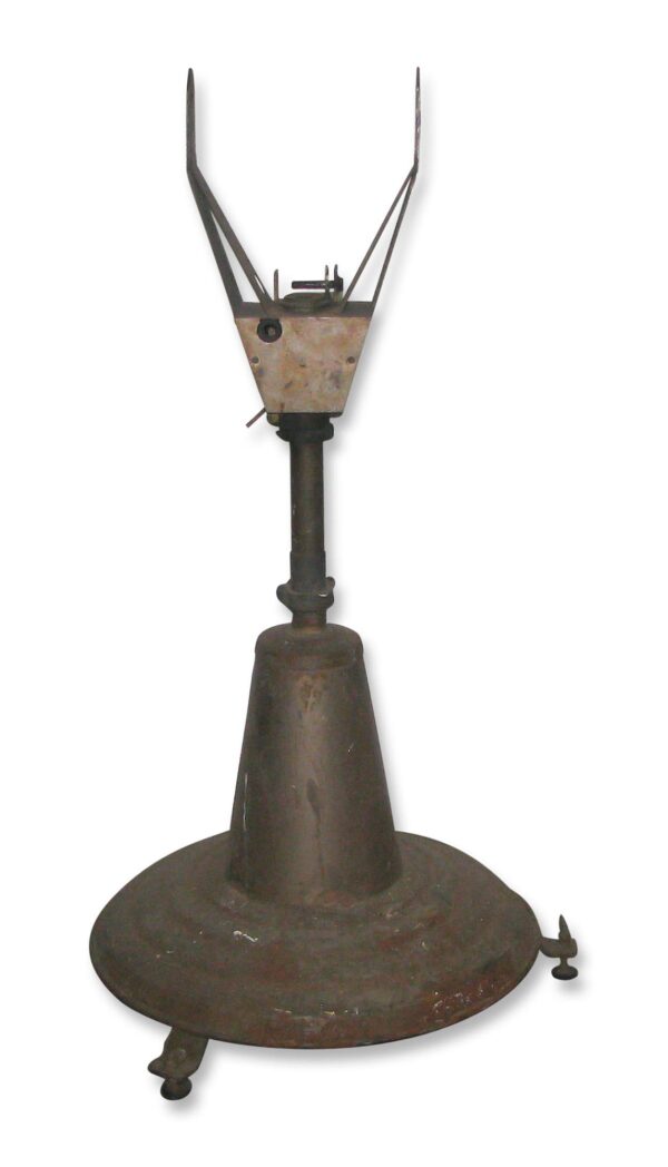 Antique metal spot light base with a rolling base and upright mounting bracket.