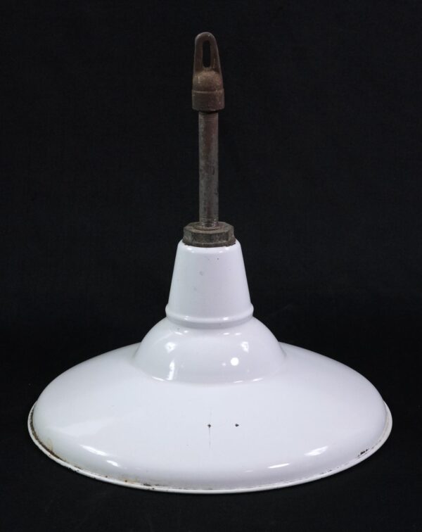 Industrial pendant light with a white enameled steel shade and short cast iron pole, shown from below with minor chips and rust visible along the rim.