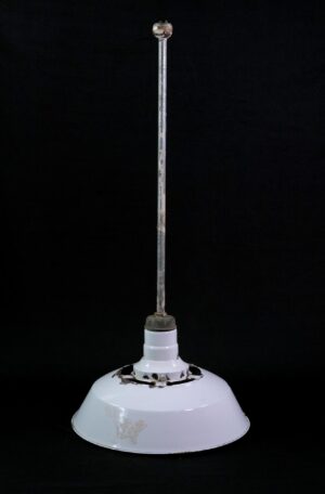 Industrial pendant light with a white enameled steel shade, long steel pole, and visible chipping and rust around the top opening and rim.