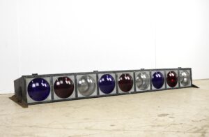 Pair of reclaimed stage lights in a steel frame with nine round red, white, and blue lenses.