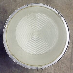 Top view of an industrial stadium spotlight with a clear ridged lens and metal retaining ring.