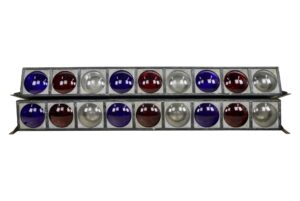 Pair of reclaimed stage lights with steel frames and nine round red, white, and blue lenses each, shown stacked one above the other.