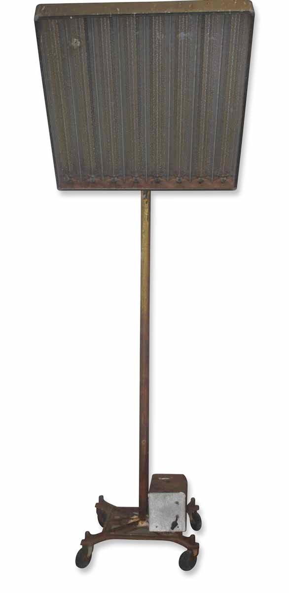 Tall reclaimed light stand with wheels and a rectangular metal reflector mounted on a cast iron base.
