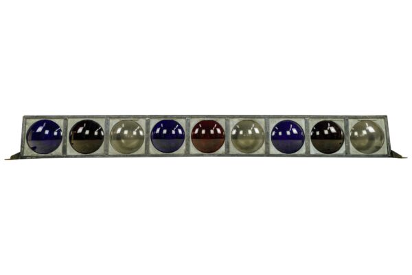 Vintage stage light with nine round lenses in a steel frame, shown in a straight-on view.