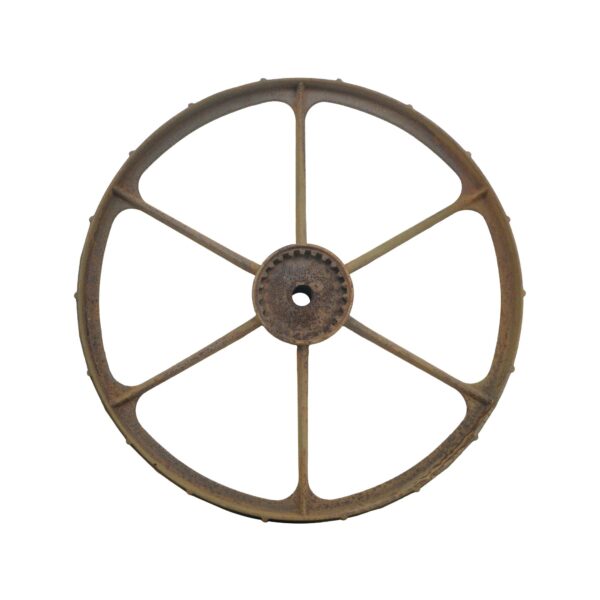 Six-spoke cast iron wagon wheel with surface rust and a central hub opening.