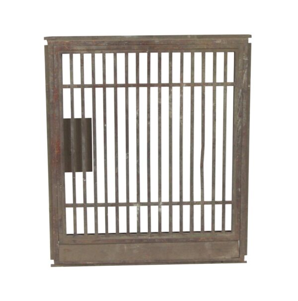 Antique bronze bank teller gate with vertical bars and a right side opening.
