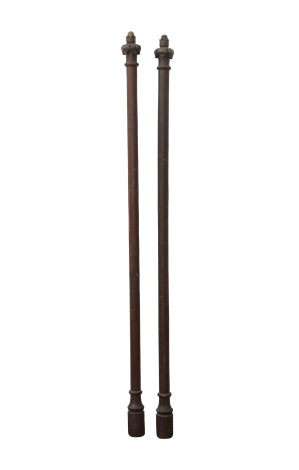 Pair of carved wall trim pieces in a dark wood tone, shown vertically with acorn finials at the top and rounded bases at the bottom.