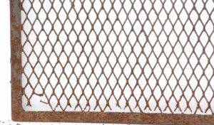 Rusty wrought iron mesh panel with a rectangular frame and diamond-pattern grid.