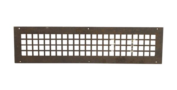 Rectangular steel wall grate with a grid of square openings and six mounting holes, shown in a front view with visible surface wear.