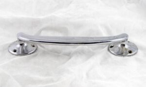 Chrome-plated door pull handle with circular bases and surface wear, shown in a front view.