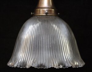 Clear ribbed glass pendant shade with a brass fitter at the top.