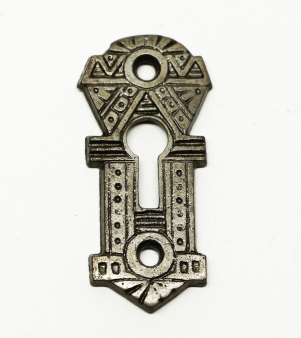 Decorative cast iron key escutcheon plate with an Aesthetic-style geometric pattern and three keyhole openings.
