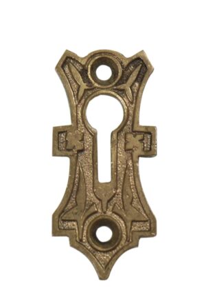 Victorian bronze keyhole cover plate with an ornate decorative shape and two mounting holes, shown front view.