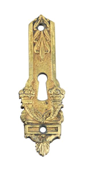 Ornate brass keyhole cover with an antique brass finish, shown vertically with decorative floral details and three mounting holes.