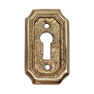 Solid brass keyhole cover with an arched edged shape and textured center, shown with keyhole opening and two screw holes.