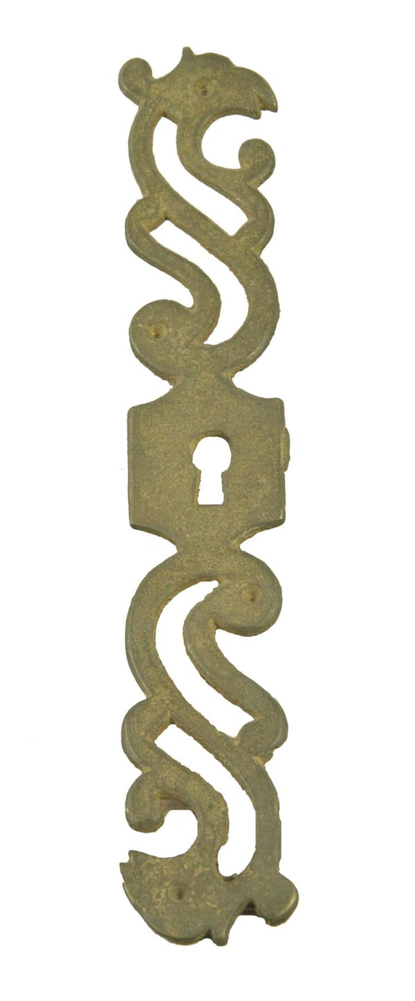Vertical antique brass keyhole plate with a griffin motif and centered keyhole cutout.