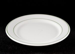White round dinner plate with green trim shown from above.