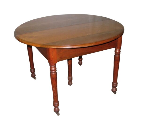 Traditional cherry table with an oval top and turned legs, shown with the leaves in place.