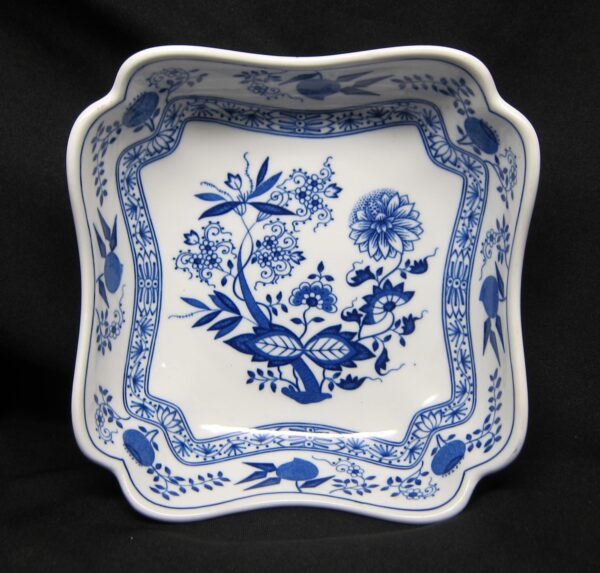 Square ceramic vegetable bowl with a scalloped rim and blue floral motif, shown from above.